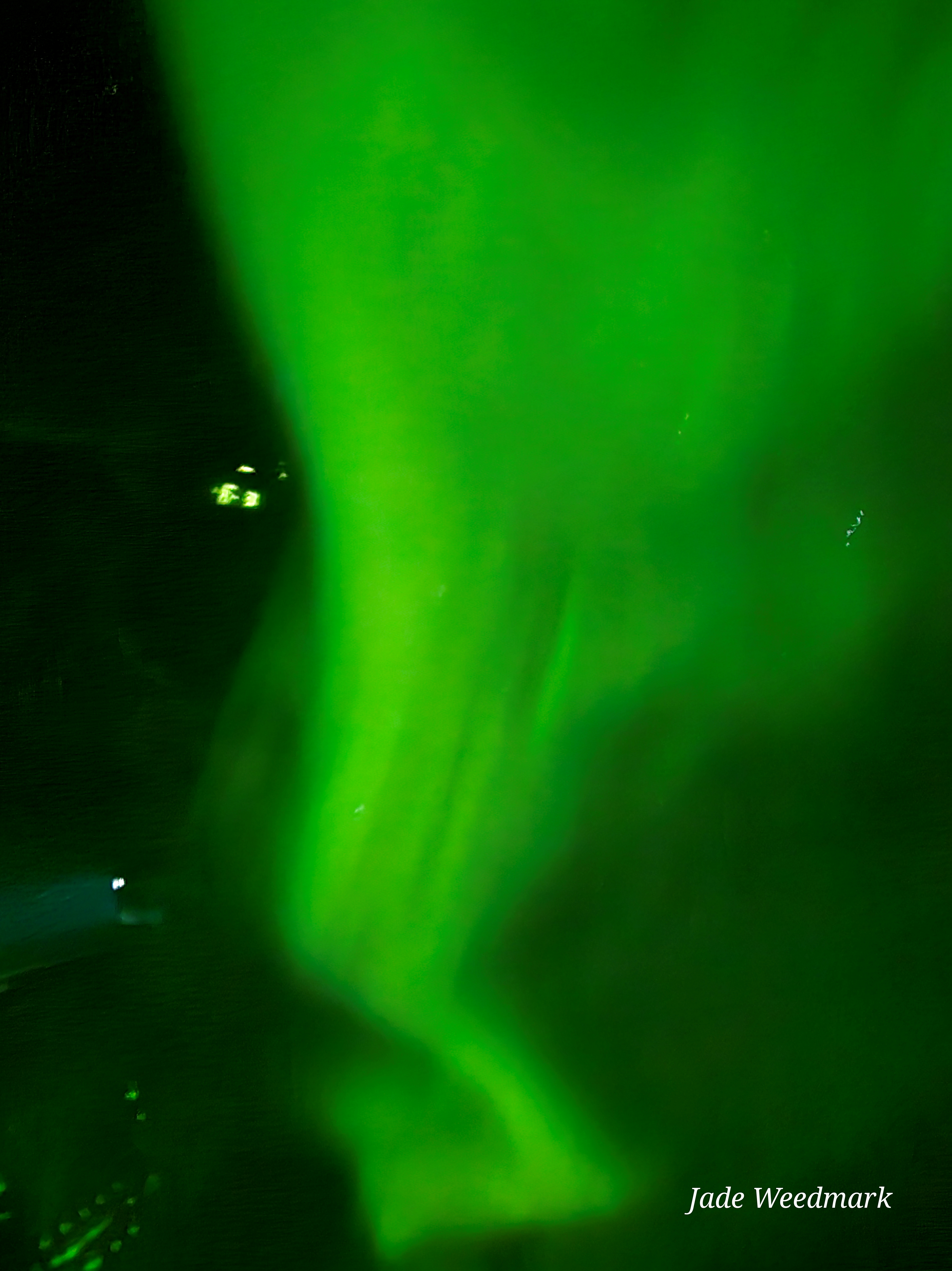 Aurora Borealis sweeping across the sky like God’s brushstrokes on a dark canvas