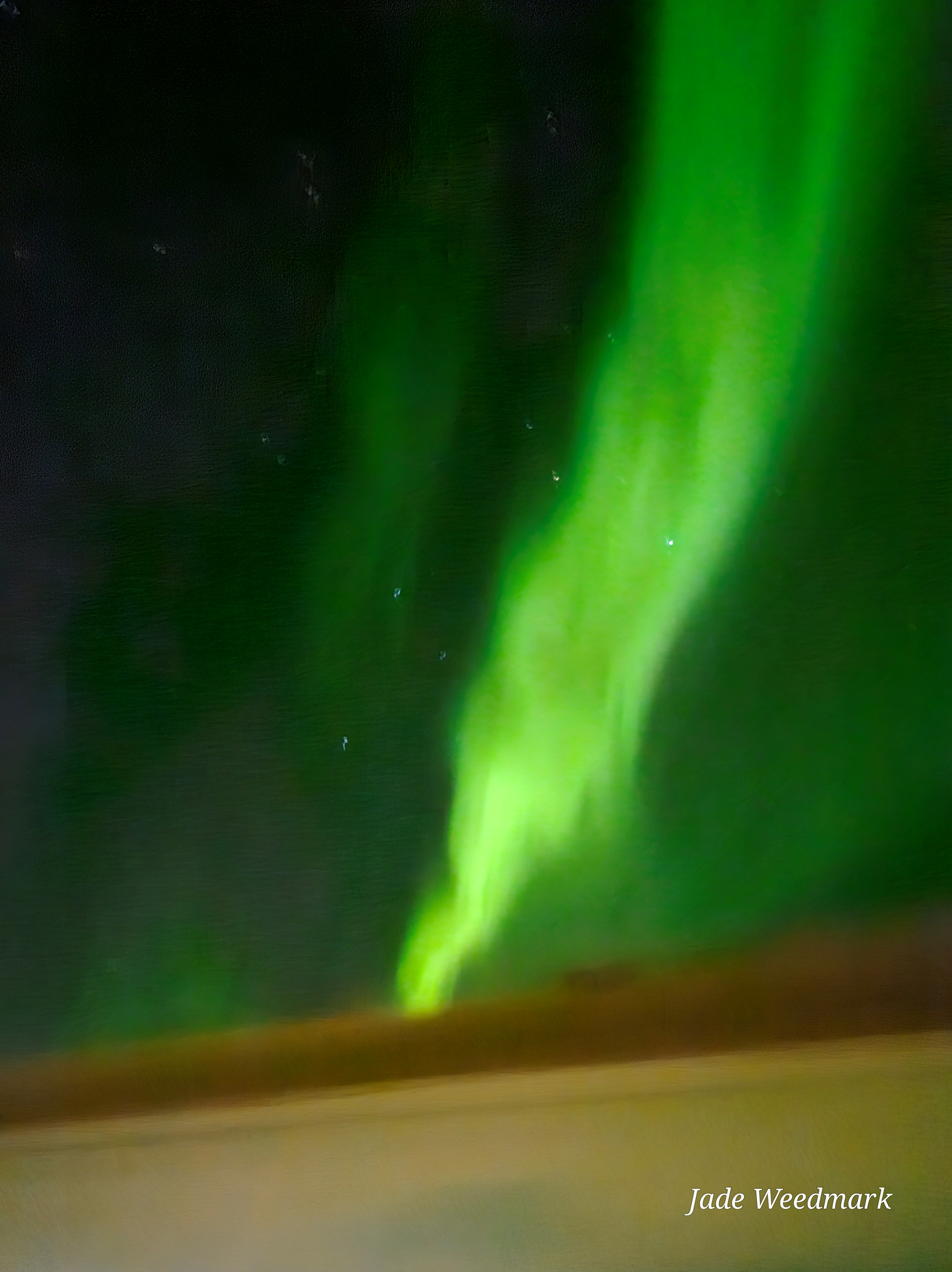 Aurora Borealis sweeping across the sky like God’s brushstrokes on a dark canvas