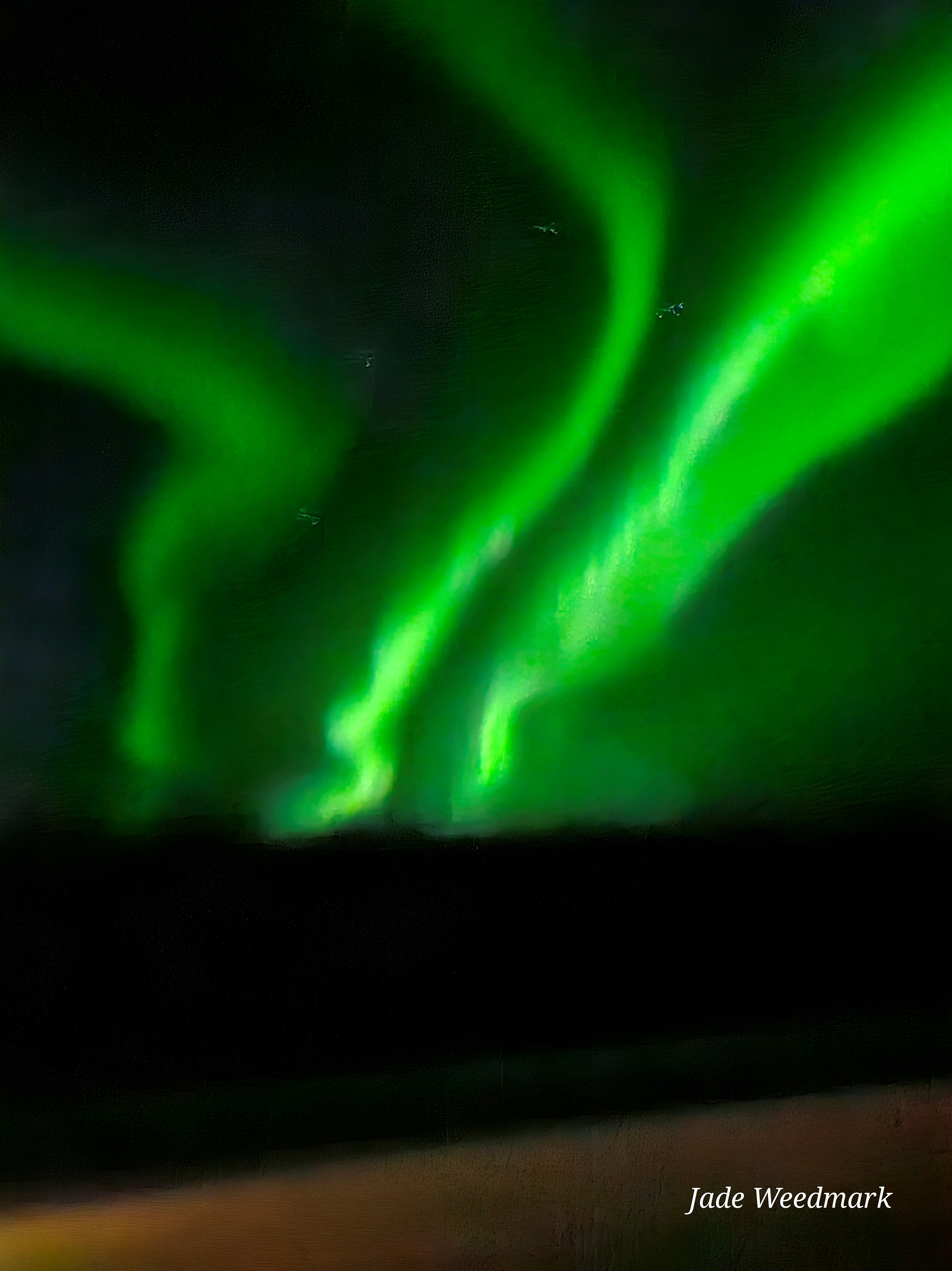 Aurora Borealis sweeping across the sky like God’s brushstrokes on a dark canvas